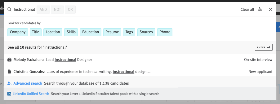 Close up of search bar with candidate name input and search results menu expanded.